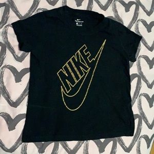 Black Nike tee with gold check mark logo.